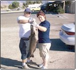 It takes two to hold up that catfish!